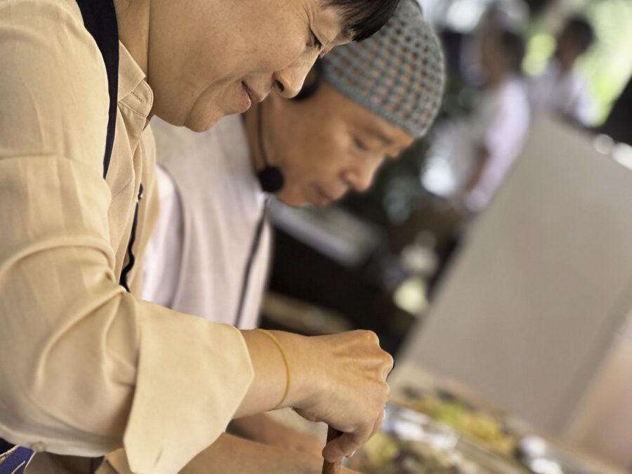 Chefs preparing dishes side by side during a Maison del Gusto masterclass at the Monaco Yacht Show